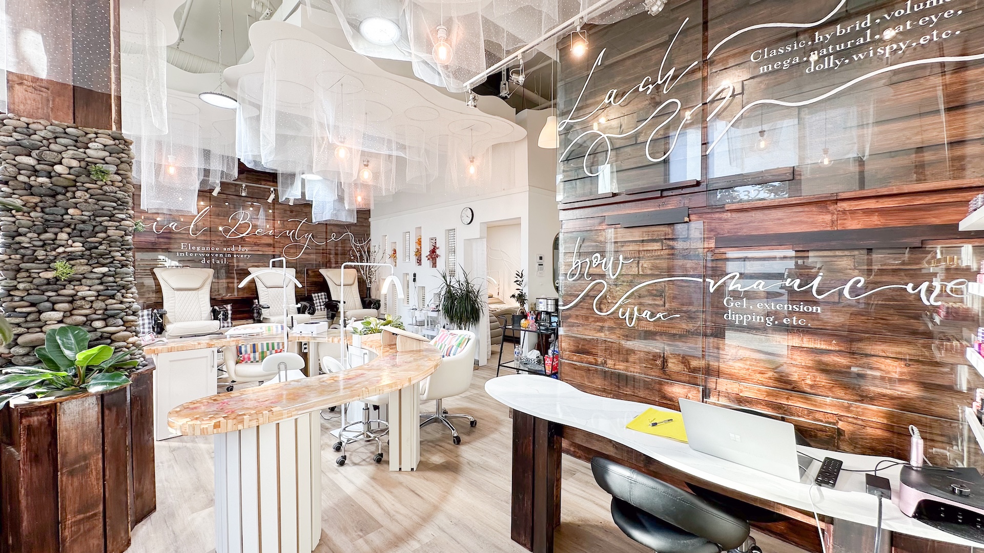 Reception wall and manicure stations at Jovial Nail Beauty
