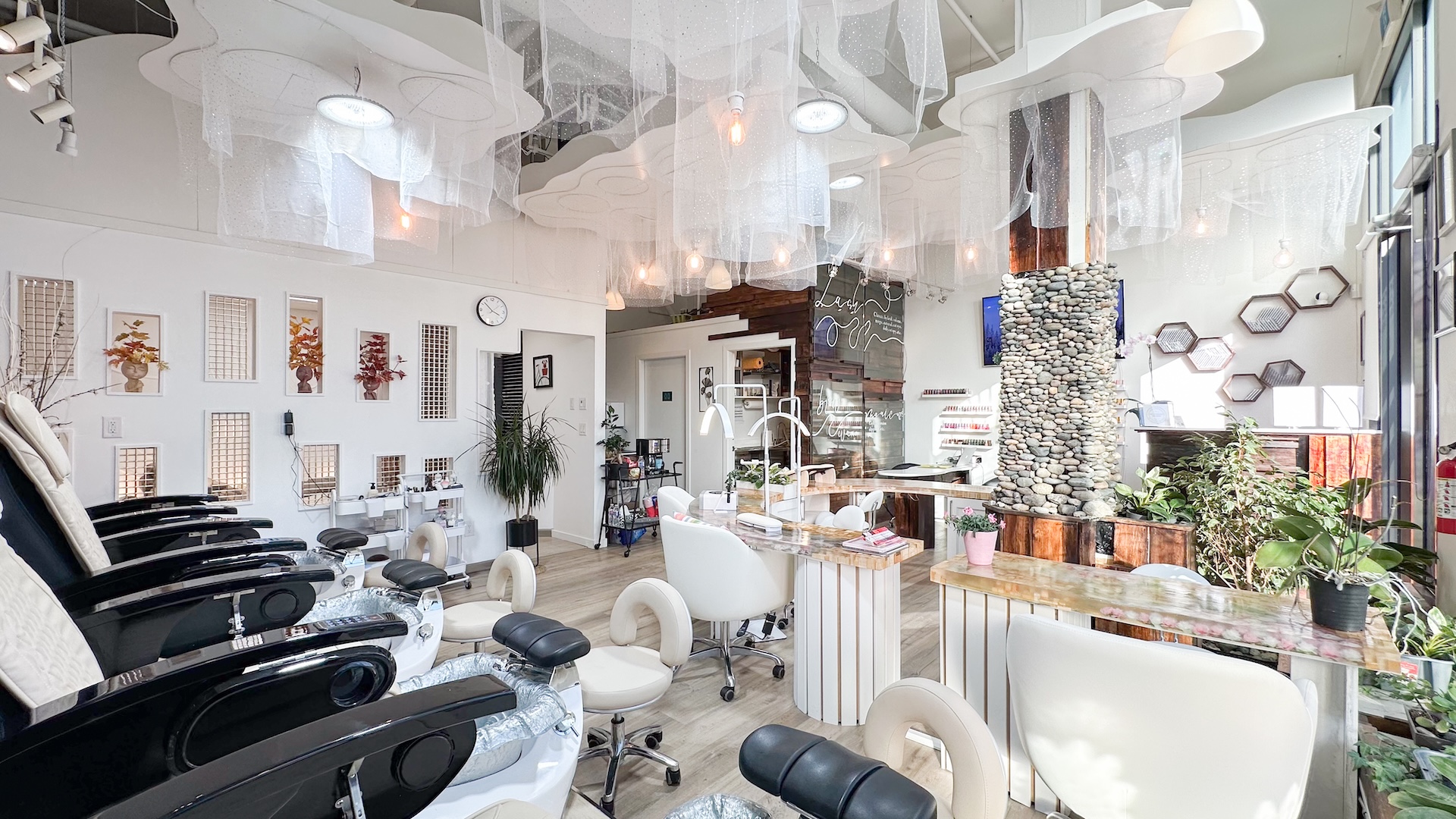 Bright pedicure chairs and nail stations inside Jovial Nail Beauty