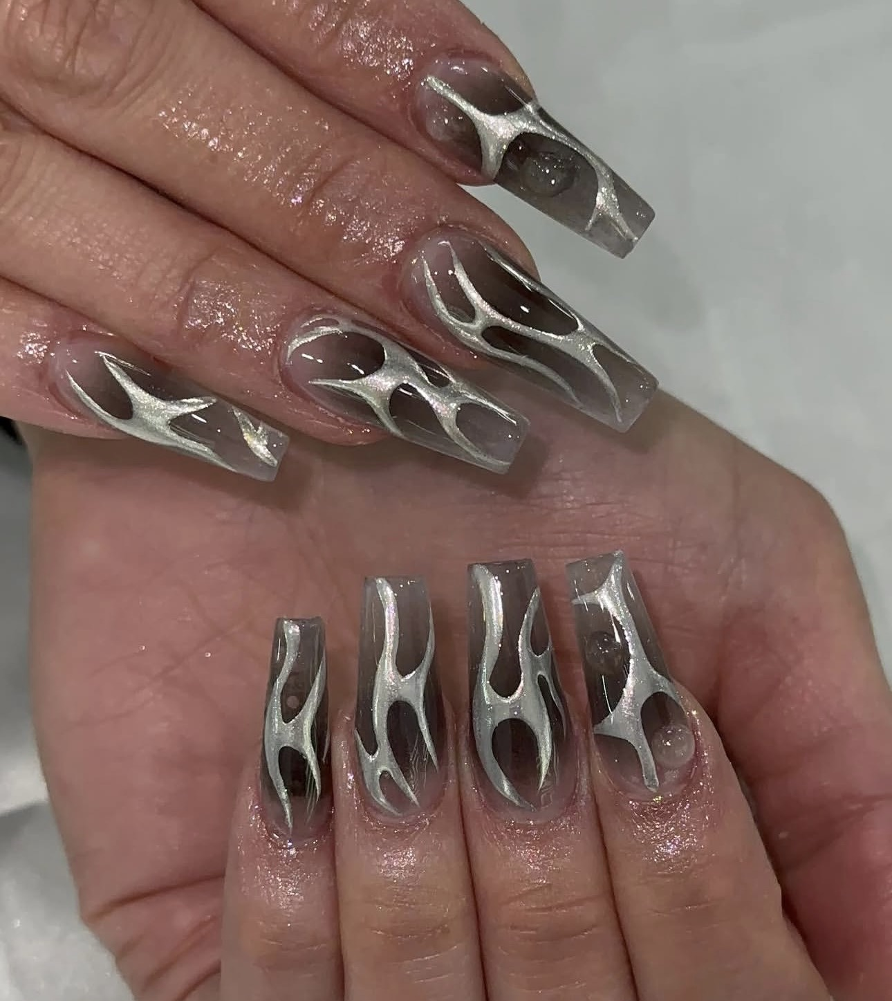 Chrome sculpted nail art with clear details