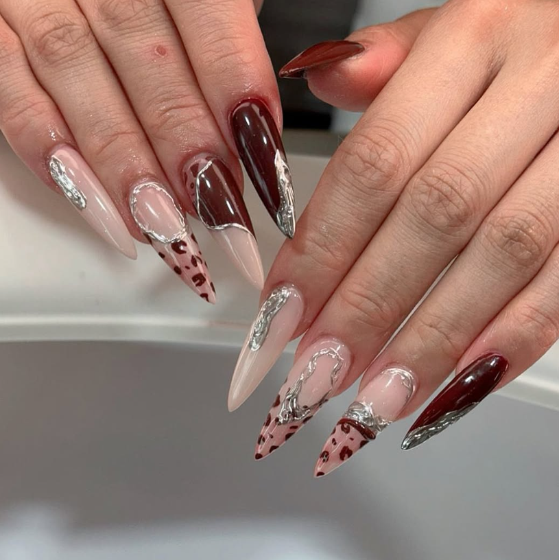 Burgundy chrome stiletto nail extensions at Jovial Beauty
